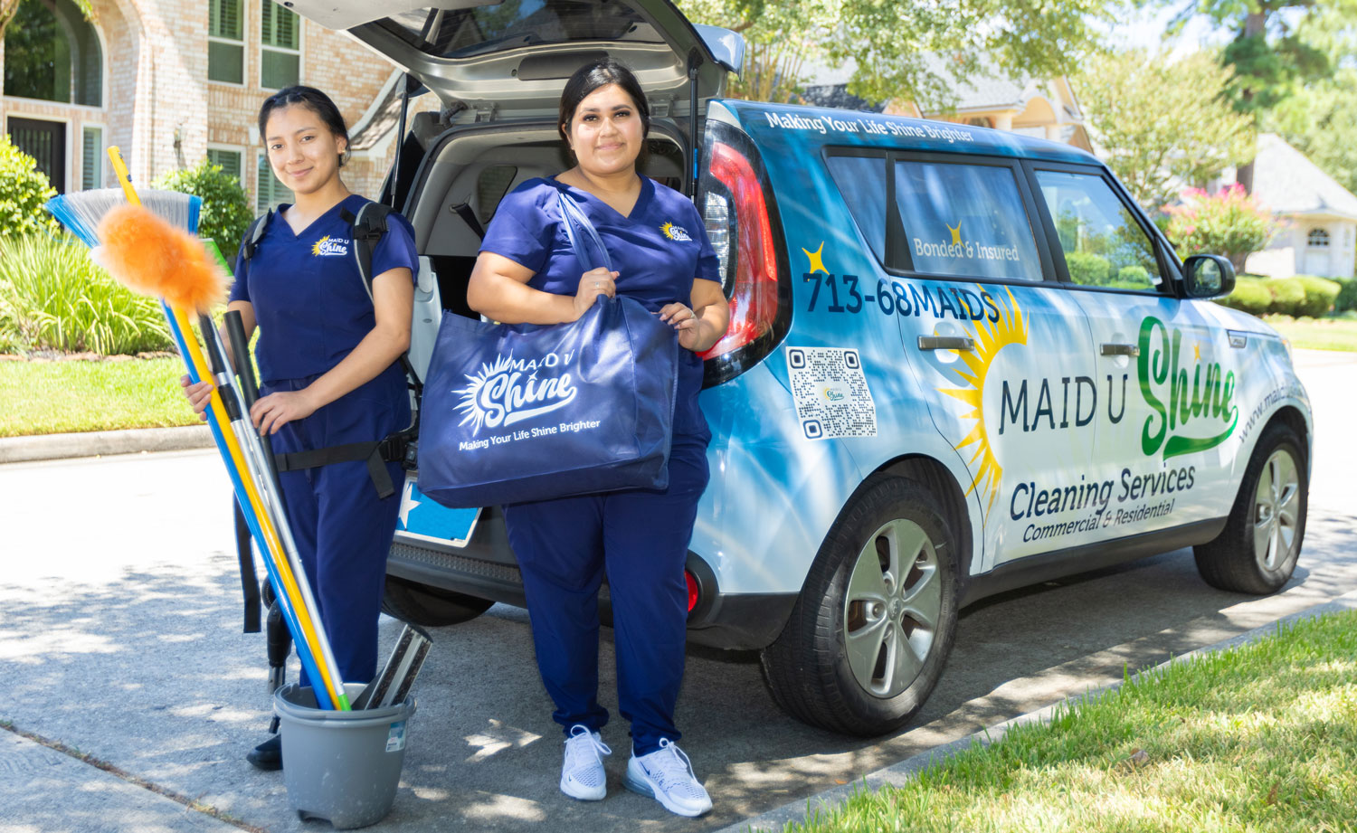 Maid U Shine cleaning team standing beside company vehicle, representing luxury house cleaning services in Houston.